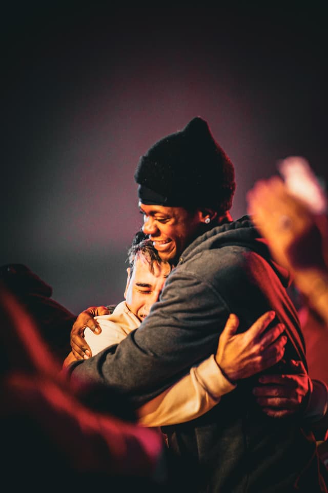 Youth embracing during worship