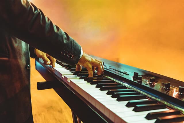 Hands playing keyboard during worship